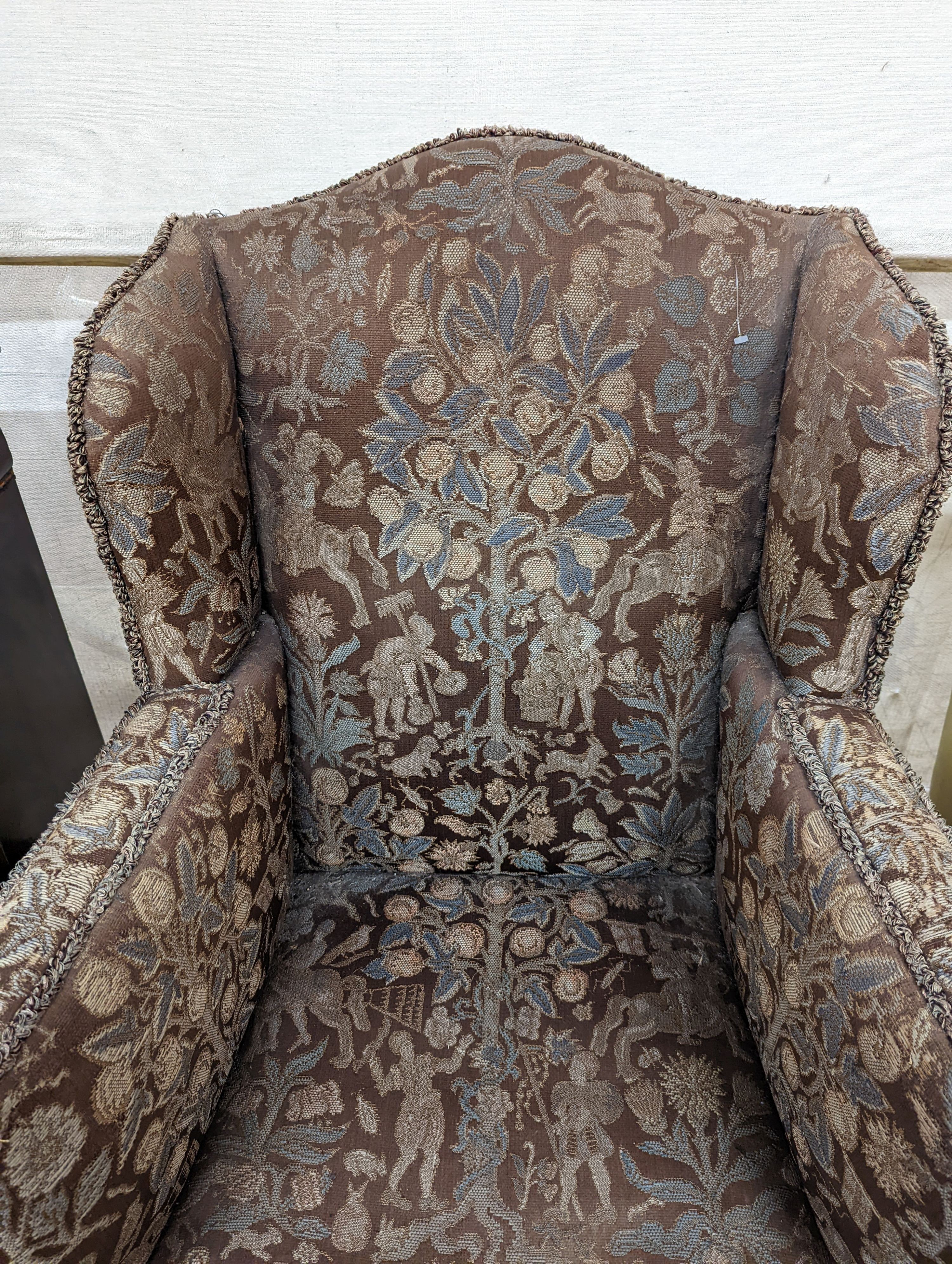 A Queen Anne revival upholstered walnut wing armchair, width 78cm, depth 78cm, height 96cm